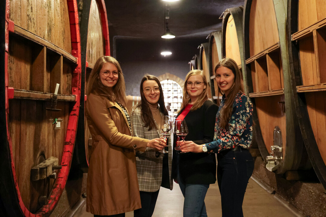 Anstoßen im Holzfasskeller der Winzergemeinschaft Franken (v. l.): Eva Brockmann, Lisa Lehritter, Laetitia Stockmeyer und Anne Gümpelein. 